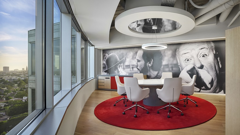 A table with chairs and a painting on it.